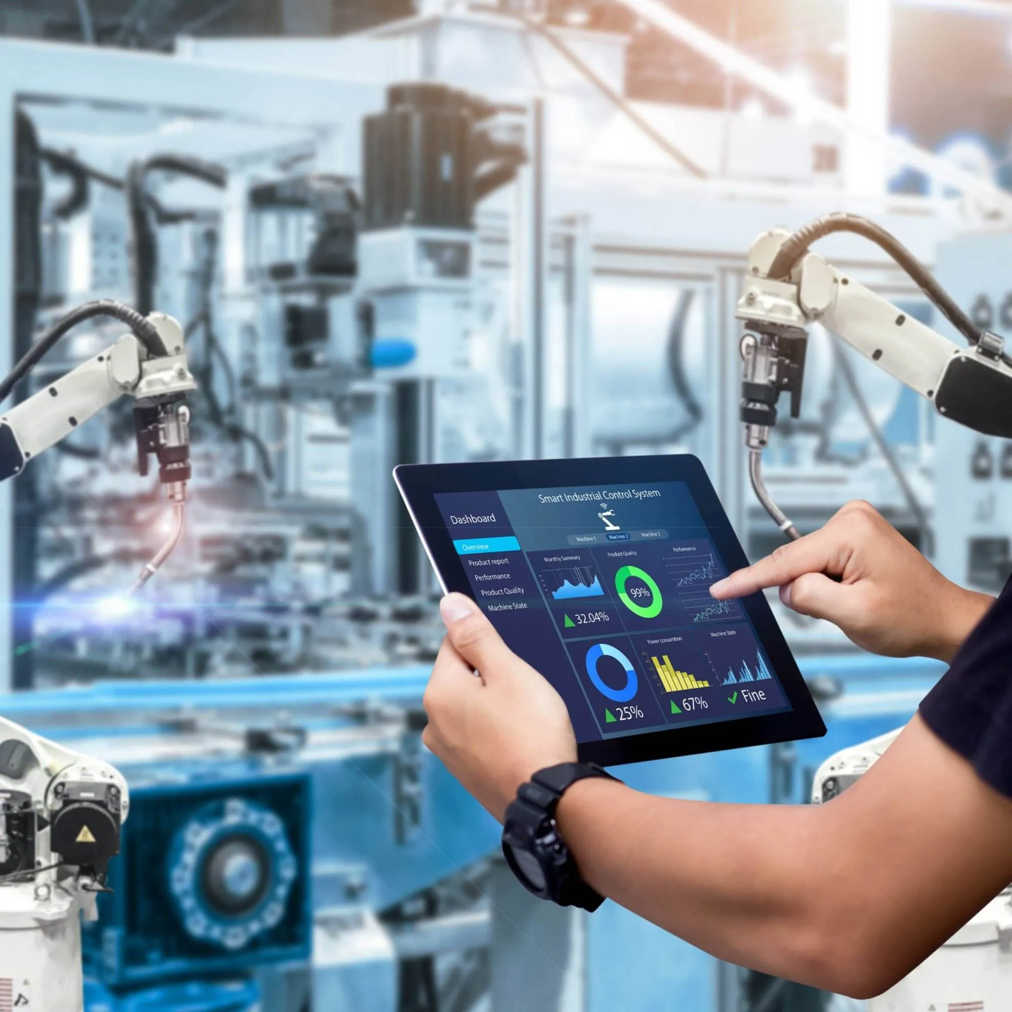 A person in a modern factory using a tablet with specialized software to control robotic arms with automation.